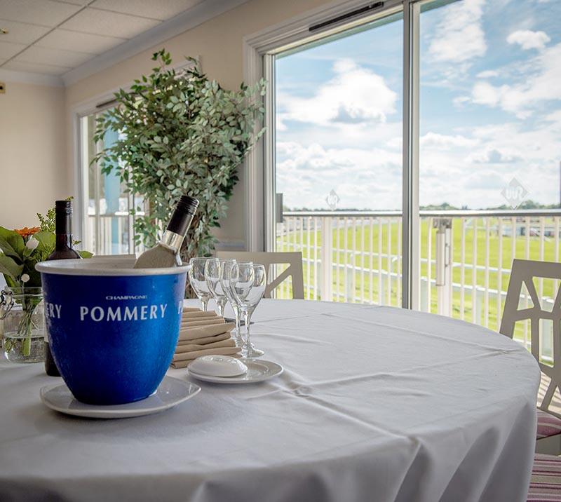 A clean and neatly prepared table with drinks on ice awaits the days guests.