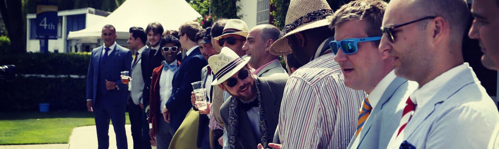 Group of dressed up gentlemen attending racing at Windsor Racecourse.