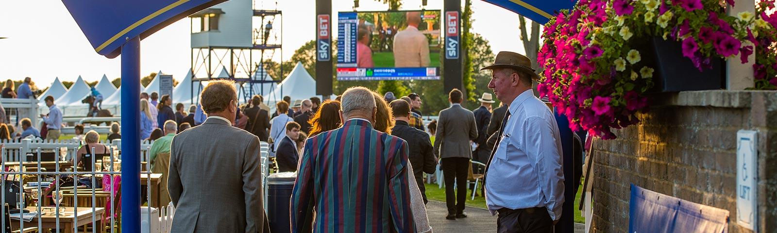 People walking through entrance to Club Enclosure at Windsor Racecourse.