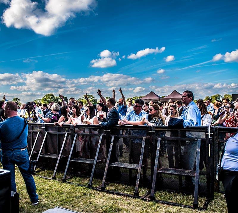A view looking back on the crowd at a music event at Royal Windsor Racecourse
